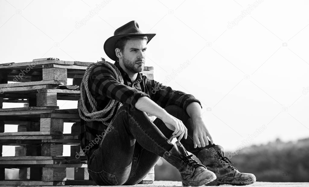 being a Texan. Vintage style man. Wild West retro cowboy. cowboy with lasso rope. Western. wild west rodeo. Thoughtful man in hat relax. western cowboy portrait. man checkered shirt on ranch