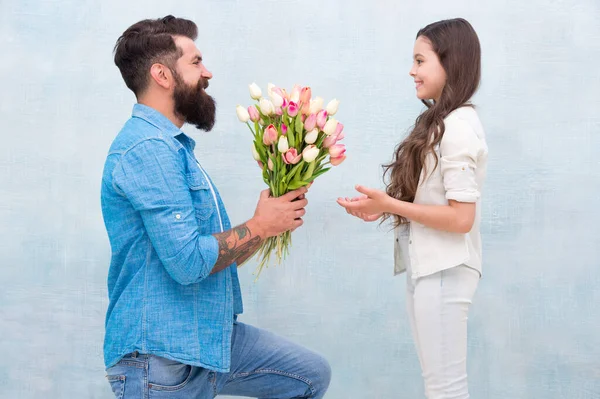 Flower shop. Family tradition. Little lady. Tender tulips for daughter. Man tulips bouquet. Father giving tulips girl. Dad with flowers. Birthday celebration. International womens day. Fathers day — Stock Photo, Image
