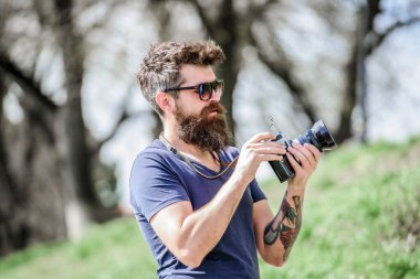 Elle ayarlar. Fotoğrafçı klasik fotoğraf makinesini tutar. Modern blogcu. Sakallı ve bıyıklı bir fotoğrafçı. Adam fotoğraf çekiyor. İçerik yaratan. Sakallı hippi fotoğrafçı. Yaşlı ama hala iyi.