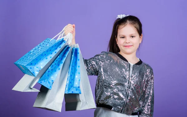 Great stores. Great choices. Girl with shopping bags violet background. Shopping and purchase. Black friday. Sale discount. Shopping day. Child hold bunch packages. Kids fashion. Surprise gift — Stock Photo, Image