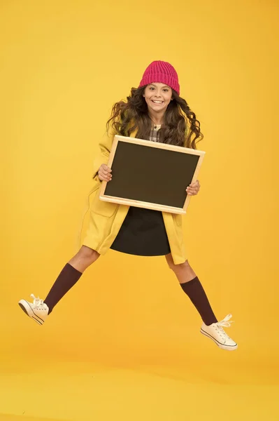 Copy space for ad. happy pupil kid jumping. back to school. desire for study. smiling child jump. retro and modern school. small girl full of enegry. stylish schoolgirl blackboard. real happiness — Stock Photo, Image