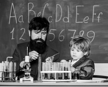 Eğitim gelişmedir. Küçük çocuk ve öğretmen adam. Bilgelik. Okula dönelim. Tahtalı eğitim odası. Bilim adamının elinde deney tüpleriyle matara. Oğlu ve babası okulda.
