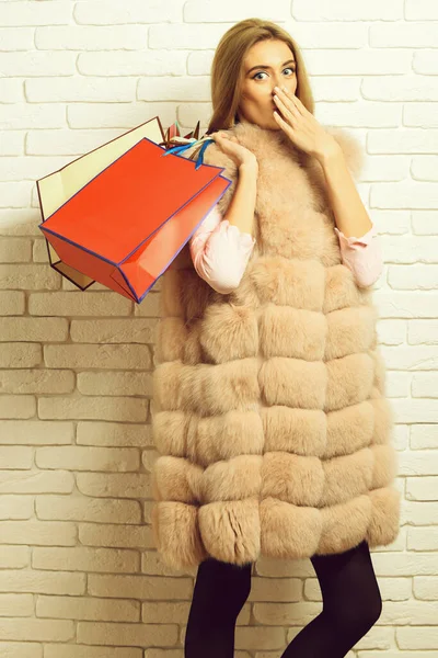 Fashionable sexy girl in fur on brick wall studio background — Stock Photo, Image