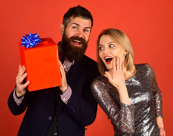 stock image Girl and bearded man with surprised faces hold gift box.