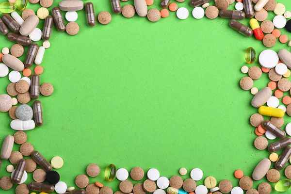 Frame border from colorful medicine capsules. Medicine concept