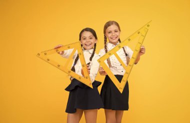 Pupil school girls big rulers. School knowledge. Explore world with math. Mathematical theory combining algebraic and geometric methods. Discover mathematics patterns. School students study geometry clipart