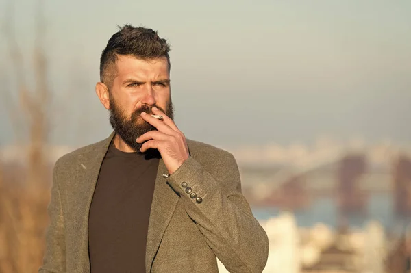 Nicotine abuse. Cigarette smoker. Bearded man smoke nicotine cigarette outdoor. Addiction to nicotine. Smoking habit comes from nicotine dependence Bad habit — Stock Photo, Image