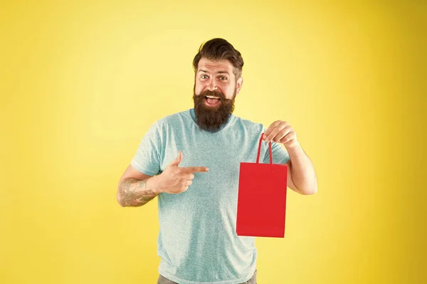 Buy product. Gender differences in purchase decision making. Happy hipster hold paper bag. Bearded man smiling with fashion purchase. Impulse purchase. Shopping concept. Shop store mall boutique — Stock Photo, Image
