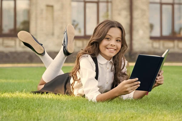 Tvoje kniha snů. Šťastný snílek. Malé dítě čte do snů. Dívka odpočívat čtení knihy na zelené trávě. Čti velký, velký sen. Učte se. Přemýšlej. Vytvořit. Sni a dosáhni — Stock fotografie