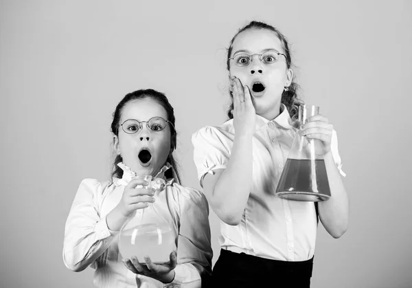 Knowledge day. Schoolgirls friends with chemical liquids. Childhood and upbringing. Knowledge and information. Experimenting together. Education concept. Basic knowledge. Fascinating experiment