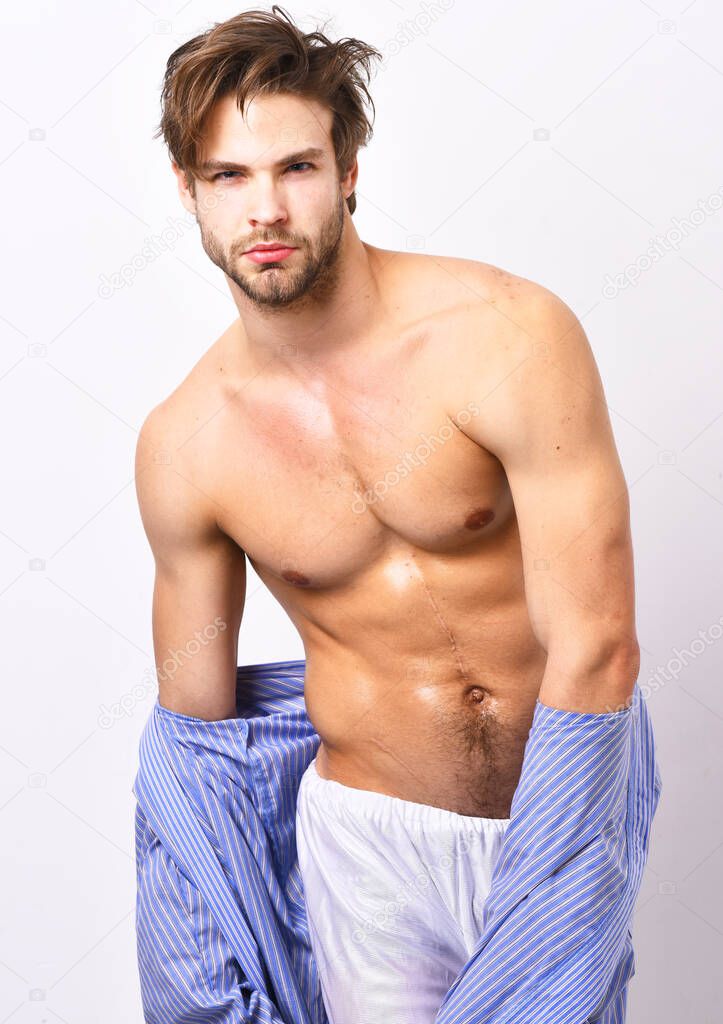 Sexy macho with muscular body in home or bath clothes.