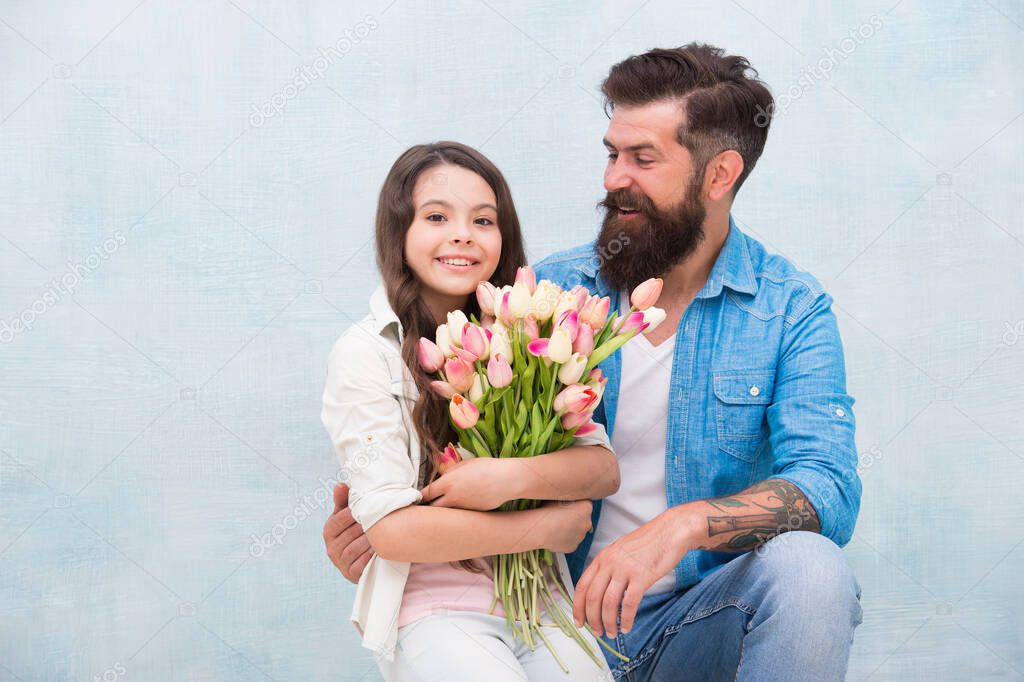 family bonding time. happy womens day on 8 march. birthday surprise for her. fathers day concept. tulip bouquet. portrait of family, daughter and father. Father and little girl enjoy spring