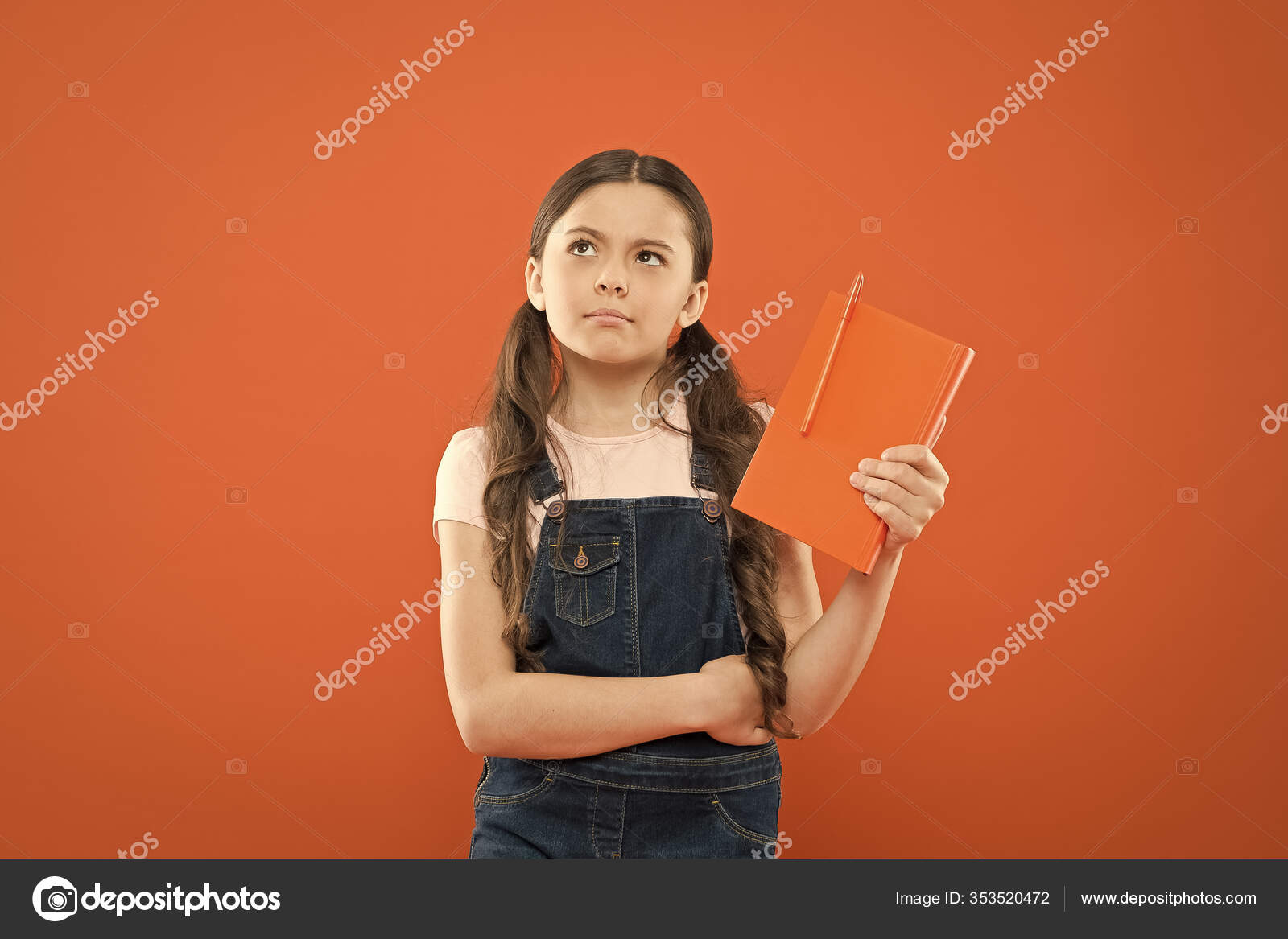 School girl read book on orange background. writing notes. kid diary. poetry  and novel. modern education. thinking little girl with notebook. literature  lesson. back to school. Diary for girl concept Stock Photo