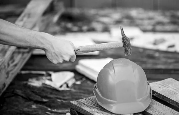 Protective helmet. Material strength. Building construction. Professional hard hat. Engineer architect repairer safety accessory. Helmet or hard hat. Hammer knocking helmet close up. Test concept