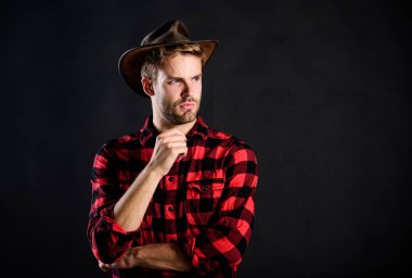 Archetypal image of Americans abroad. Cowboy life came to be highly romanticized. Man unshaven cowboy black background. Masculinity and brutality concept. Adopt cowboy mannerisms as a fashion pose clipart