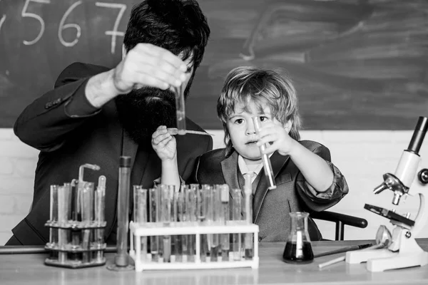 Genius minds. Signs your child could be gifted. Genius toddler private lesson. Genius kid. Teacher child test tubes. Chemical experiment. Joys and challenges raising gifted child. Special and unique