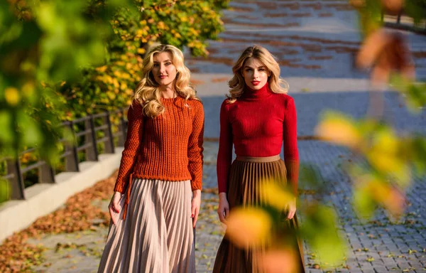 Fall fashion. Pleated skirt fashion trend. Women walking in autumn park. Friends girls. Autumn stylish outfit. Adorable ladies enjoy sunny autumn day. Fashionable clothes. Femininity and tenderness — Stock Photo, Image
