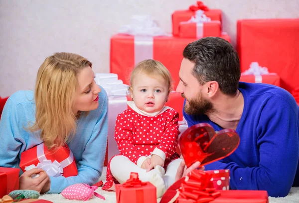 Present for you. Love and trust in family. Bearded man and woman with little girl. Valentines day. Red boxes. father, mother and doughter child. Happy family with present box