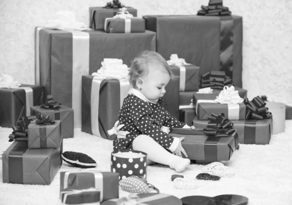 Gifts for child first christmas. My first christmas. Sharing joy of baby first christmas with family. Baby first christmas once in lifetime event. Little baby play near pile of wrapped red gift boxes — Stock Photo, Image