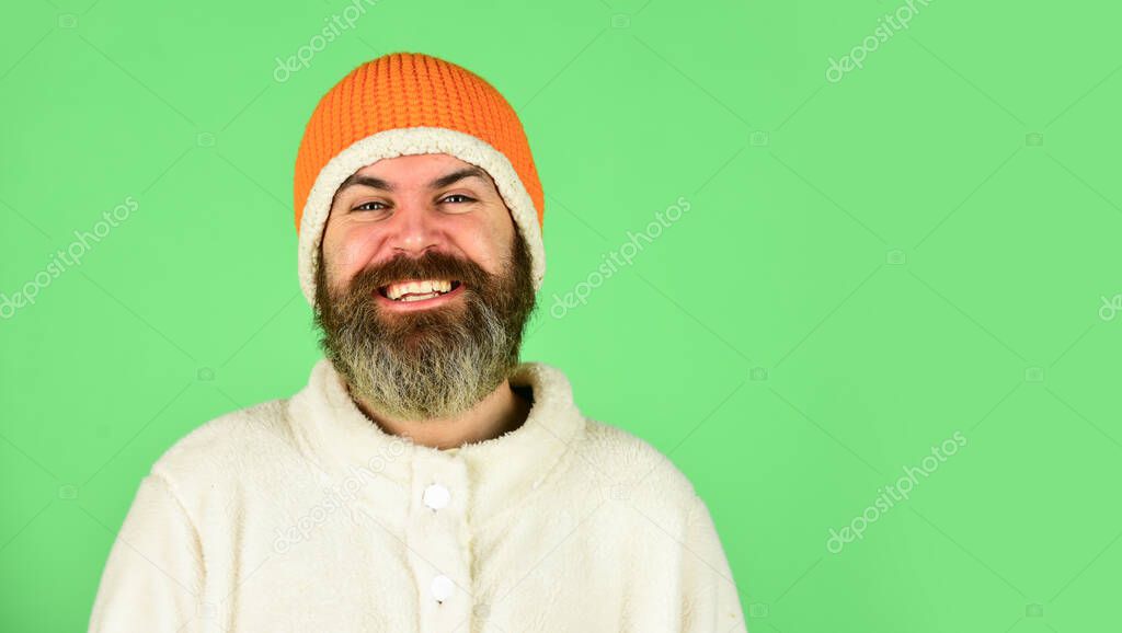 Lets celebrate. cold and flu. Portrait of brutal man in fleece sweatshirt. Handsome male model wearing warm hat. casual man in winter hat and warm clothes. happy hipster wear warm hat. copy space