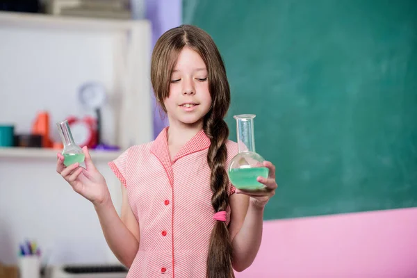 Fascinating lesson. Chemical reaction. Chemical liquid. Science lesson. School laboratory. Small girl with chemical tube. Biology education. Girl chemistry class testing tube. Scientific experiment