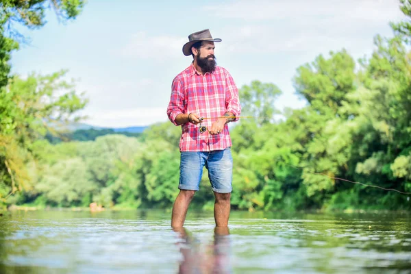 Un umore calmo e pacifico. Pescatore solo stare in acqua di fiume. Un pescatore barbuto. Attrezzatura da pesca dei pescatori. Una specie di meditazione. Pesci normalmente catturati in natura. Un allevamento di trote. Hobby attività sportive — Foto Stock