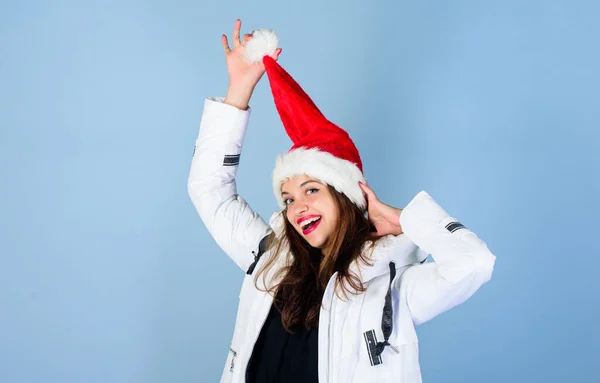 Santa girl. Girl wear white jacket and santa hat. Jacket has extra insulation to protect your body from sharp winter weather. White jacket. Waiting frosty christmas days. Emotional woman makeup face