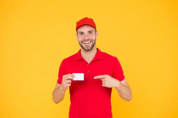 Happy to serve. Discount card. Business contact. Delivered to your destination. Service delivery. Courier and delivery. Postman delivery worker. Man red cap yellow background. Delivering purchase