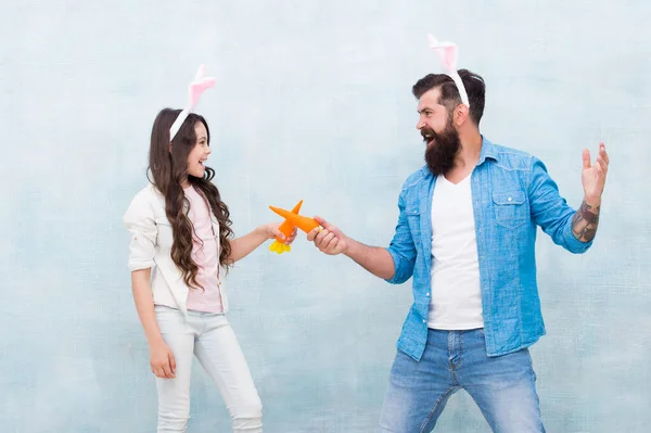 In playful mood. family start carrot fight. spring holiday with family. party fun in hare costume. happy daughter and father celebrate easter. happy easter. little girl wear funny bunny ears with dad — Stock Photo, Image