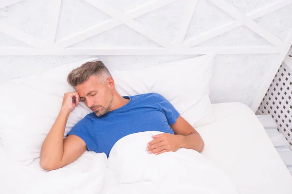 Need more rest. Peaceful mature man relaxing. Good Sleep is Reachable Dream. World Sleep Day. Benefits of good and healthy sleep. Breathe Easily, Sleep Well. Handsome man in bed. Sleeping guy at home