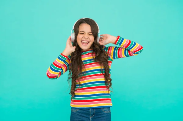 Catch my wave. small girl listen music in headphones. audio book literature for children. teen kid express positivity. optimistic schoolgirl wear colorful clothes. best summer hits. on positive tune — Stock Photo, Image