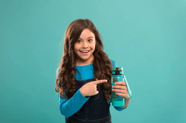Carry refillable bottle everywhere. Living healthy life. Health and water balance. Girl hold water bottle. Kid girl long hair has water bottle. Water balance concept. Drink some liquids. Ecology Stock Photo