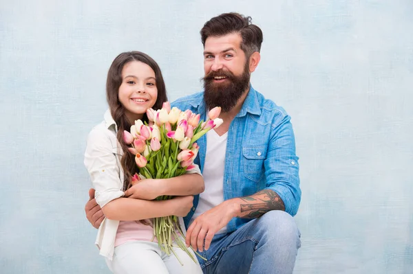 Cherishing femininity. 8 march. Tulips for daughter. Man tulips bouquet. Father giving tulips girl. Dad with flowers. Birthday celebration. International womens day. Flower shop. Family tradition — Stock Photo, Image