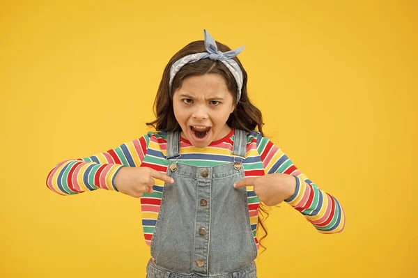 childhood problems and transition period. retro girl express rebellion. little child yellow background. angry and naughty kid. little beauty handkerchief long hair. schoolgirl vintage style