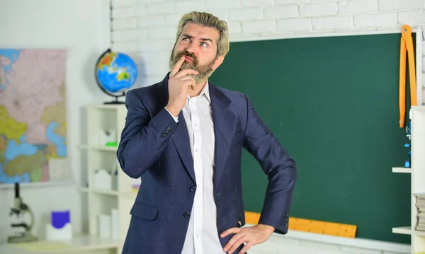 Each School defines final examination sessions. Modern teacher lesson. Study and education. Modern school. Knowledge day. Handsome bearded man in classroom chalkboard. Modern teaching method