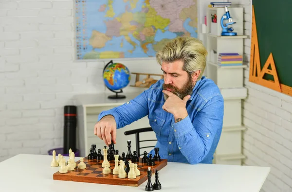 Intellectual hobby. School teacher. Board game. Playing chess. Development logics. Chess is life in miniature. Chess lesson. Figures on wooden chess board. Thinking about next step. Strategy concept