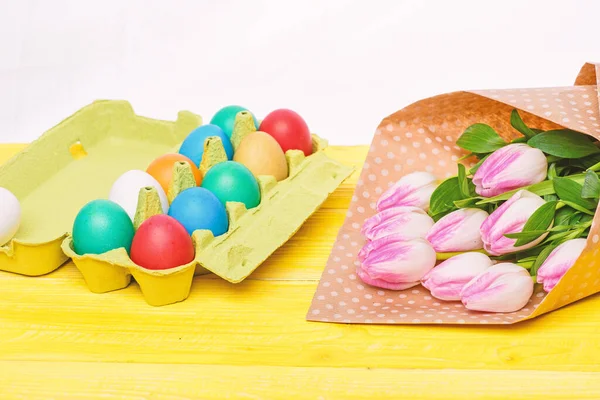 Tulip flower bouquet. Healthy and happy holiday. painted eggs in egg tray. Spring holiday. Holiday celebration, preparation. Happy easter. Egg hunt. Easter menu