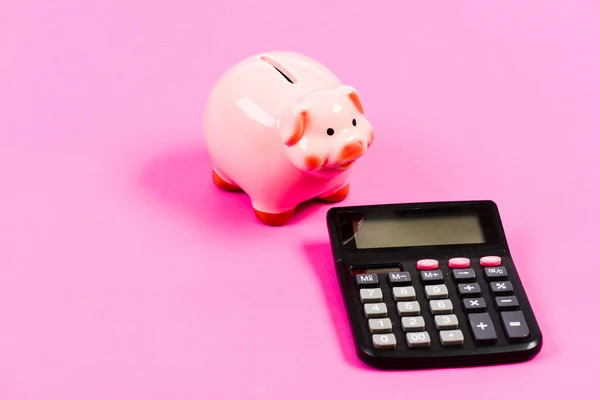 Taxes and fees concept. Tax savings. Piggy bank money savings. Investing gain profit. Pay taxes. Calculate taxes. Piggy bank pig and calculator. Taxes and charges may vary. Accounting business