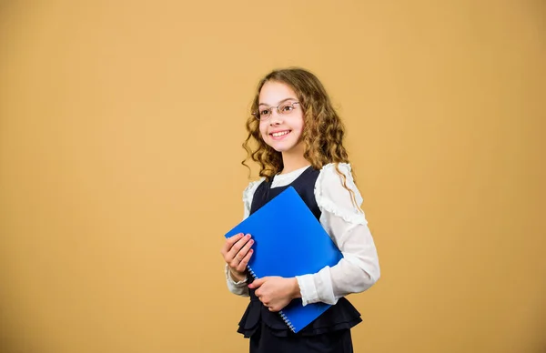 Girl hold textbook folder test. Preparing to exams in library. Small child formal wear. Formal education and homeschooling. Check knowledge. School exam concept. Prepare for exam. Final exam coming — Stock Photo, Image