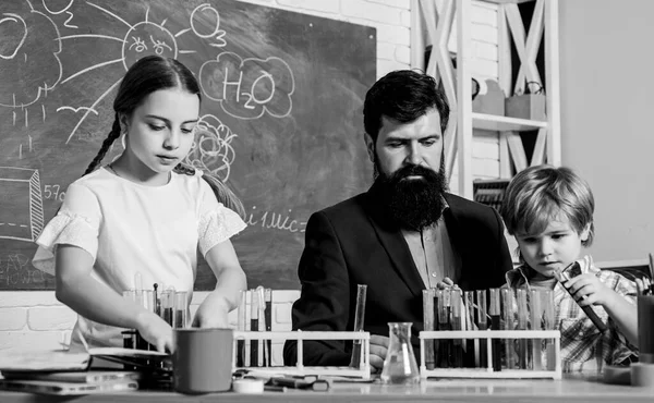 School clubs interactive education. Teacher and pupils test tubes in classroom. After school clubs are great way to develop kids in different areas. Clubs for preschoolers. Chemistry experiment