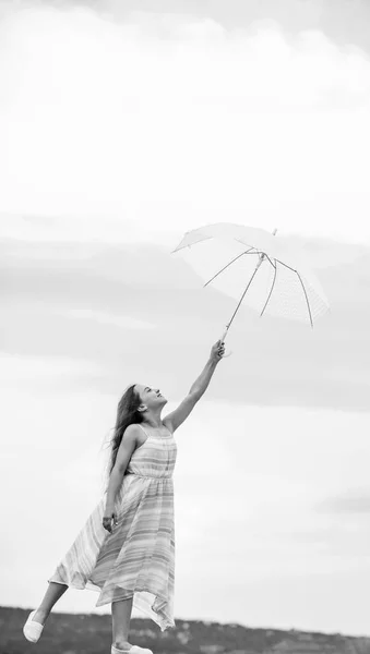 Girl with light umbrella. Anti gravitation. Fly drop parachute. Dreaming about first flight. Kid pretending fly. I believe i can fly. Touch sky. Fairy tale character. Happy childhood. Feeling light — ストック写真