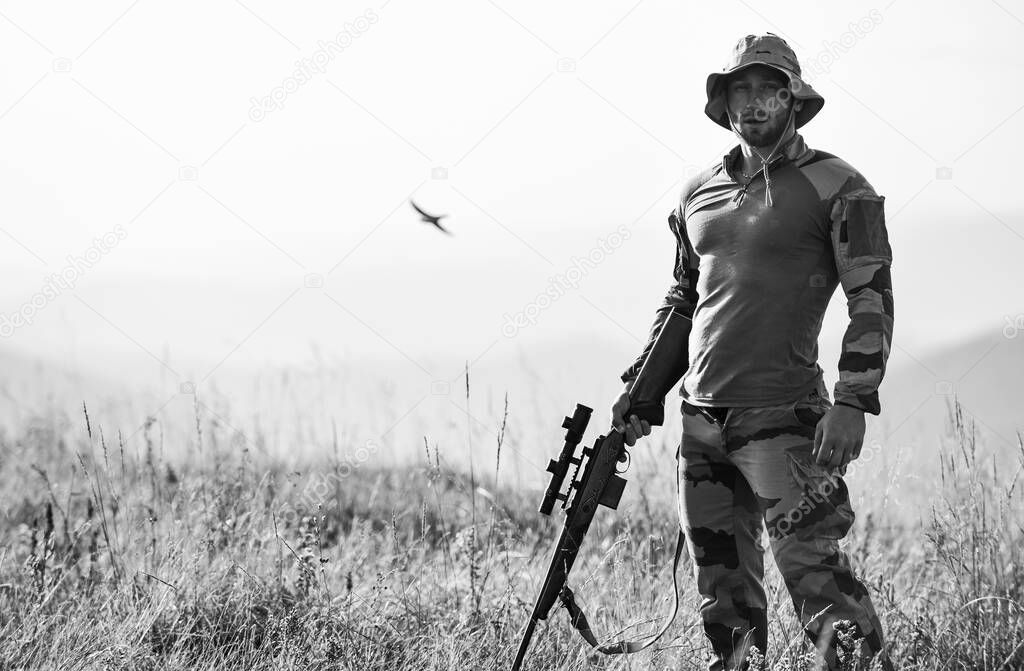 Rifle for hunting. Hunter hold rifle. Hunter mountains landscape background. Ready to shoot. Army forces. Man military clothes with weapon. Focus and concentration experienced hunter. Brutal warrior