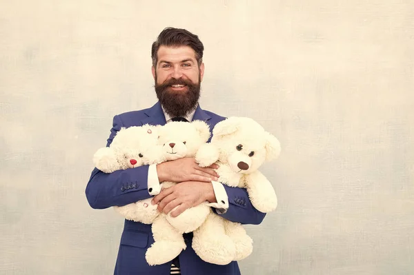 Childish excitement. Childish businessman cuddle soft toys. Bearded man dream of childhood. Childish adult. Happy and childish — Stock Photo, Image