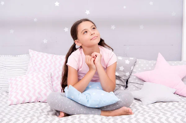 Lost in thoughts. Serious girl thinking in bed. Little child with serious look. Daydreaming. Flight of imagination. Creative mind. Serious but imaginative. Child development. All serious — Stock Photo, Image