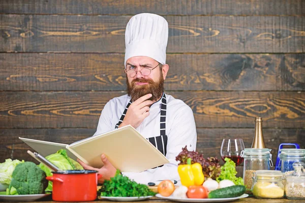 Chef profesional en uniforme de cocinero. Feliz barbudo cocinando en la cocina. Dieta con alimentos orgánicos. Verduras frescas. Comida sana y vegetariana. Vitamina. hombre utilizar utensilios de cocina. Cocinar sano — Foto de Stock