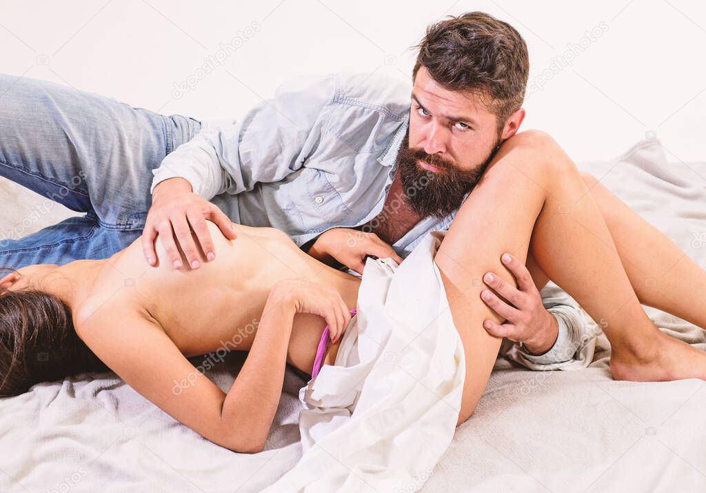 Couple make love sex. Hipster lover and sexy naked female full of desire. Sexual desire concept. Erotic game in bed. Man full of desire tease partner sensual foreplay. Seduction art and desire