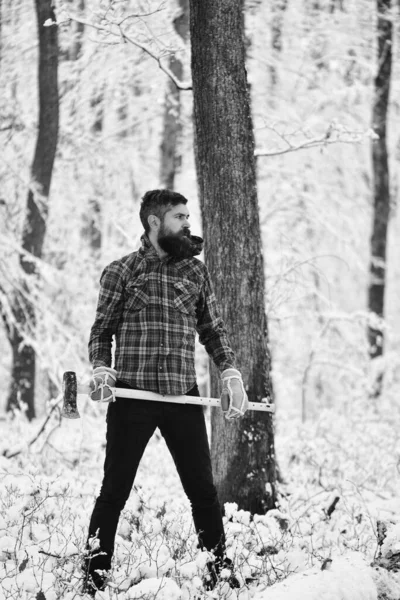 Hombre con guantes calientes y chaqueta a cuadros en el bosque . — Foto de Stock