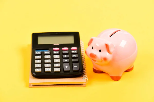 Bookkeeping. financial report. business start up. Working with numbers. family budget management. piggy bank with calculator. Moneybox. saving money. First salary. Business failure — Stock Photo, Image