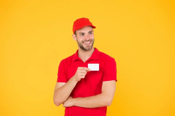 home delivery using credit card as payment. Pizza delivery man hold business card. man pay deliverer. pay with bank card. methods of payment with terminal. Delivery concept. postman in red uniform