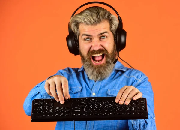 feeling of excitement. man headphones and keyboard. Professional Gamer Playing computer game. chat online. Online Video Game. Cyber Championship. agile business. downloading music from internet